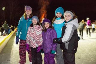 People outside near a bonfire. 